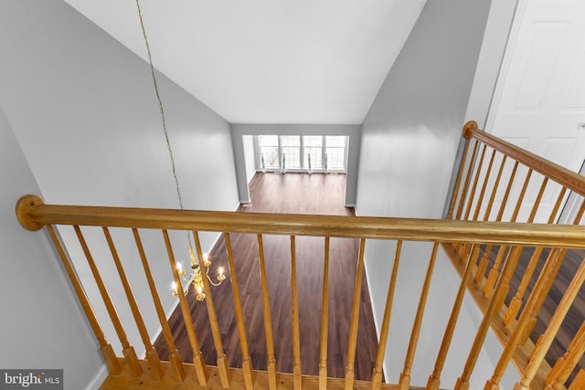 stairway featuring an inviting chandelier