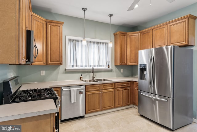 kitchen featuring stainless steel appliances, brown cabinetry, and a sink