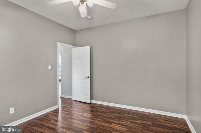 empty room featuring ceiling fan, baseboards, and wood finished floors