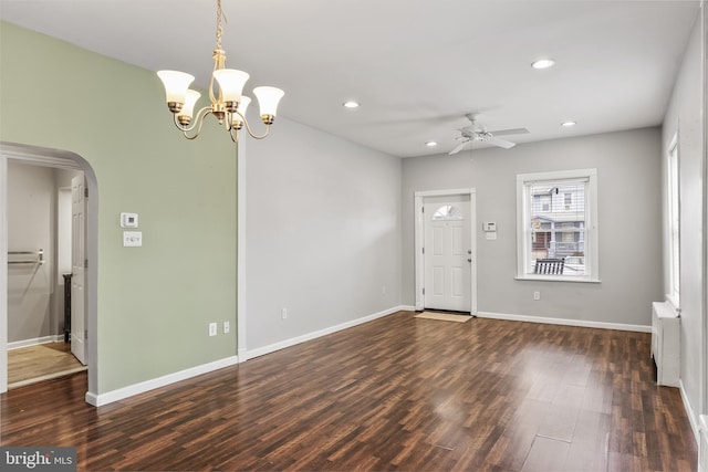 entryway featuring arched walkways, baseboards, recessed lighting, and wood finished floors