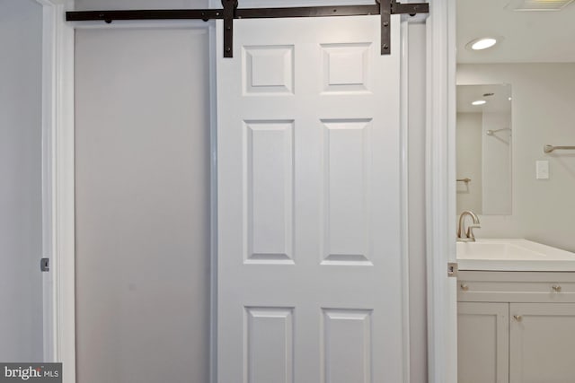 bathroom featuring vanity, recessed lighting, and visible vents