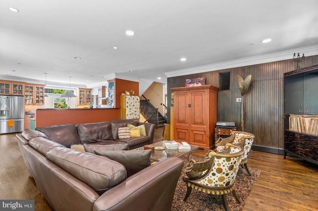 living area with crown molding, wood finished floors, and recessed lighting