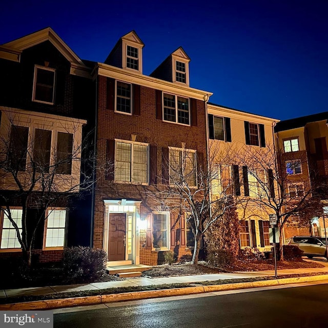 townhome / multi-family property featuring brick siding