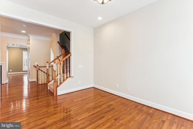 unfurnished room with stairs, recessed lighting, wood finished floors, and baseboards