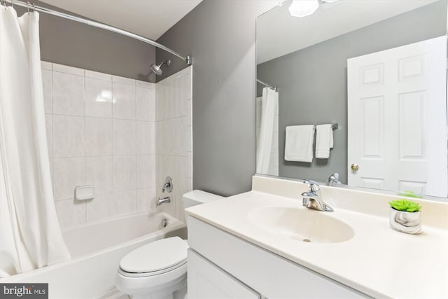 bathroom with shower / bathtub combination with curtain, toilet, and vanity