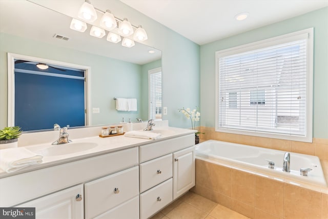 bathroom with tile patterned floors, visible vents, a garden tub, a sink, and double vanity