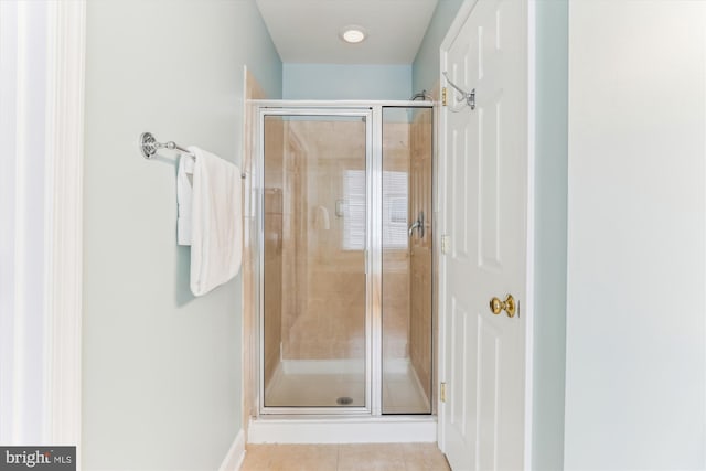 full bath with a shower stall and tile patterned floors