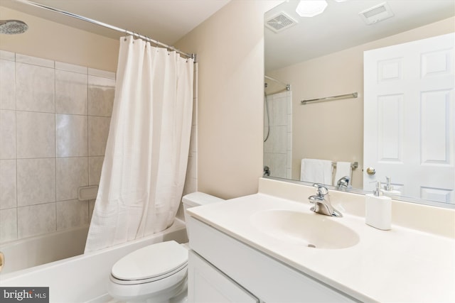 bathroom with vanity, shower / tub combo, toilet, and visible vents