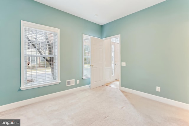 interior space with plenty of natural light, baseboards, and visible vents