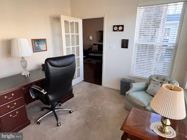 office with french doors and light colored carpet