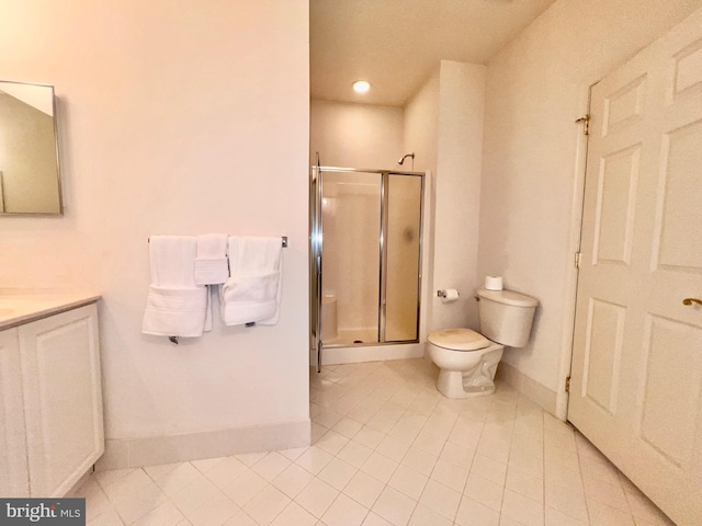 full bath with toilet, a stall shower, vanity, and baseboards