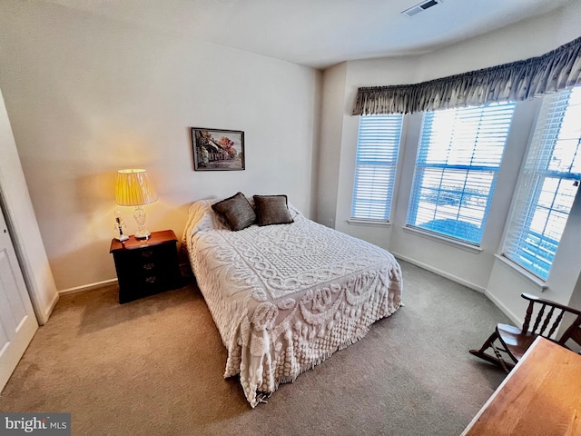 carpeted bedroom with visible vents and baseboards