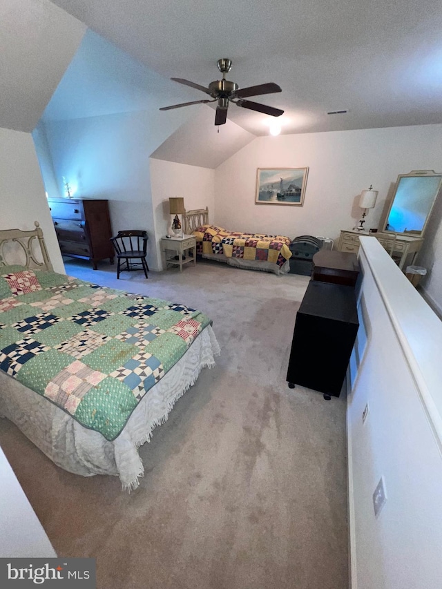 carpeted bedroom with ceiling fan, vaulted ceiling, and a textured ceiling