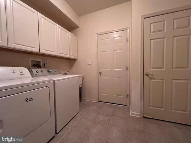 clothes washing area with cabinet space, washer and clothes dryer, baseboards, and light tile patterned floors