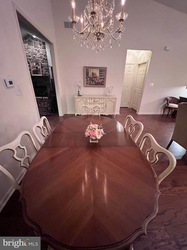 dining space with a chandelier, dark wood-type flooring, and visible vents