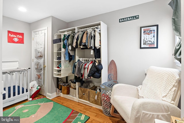 bedroom featuring a closet, baseboards, and wood finished floors