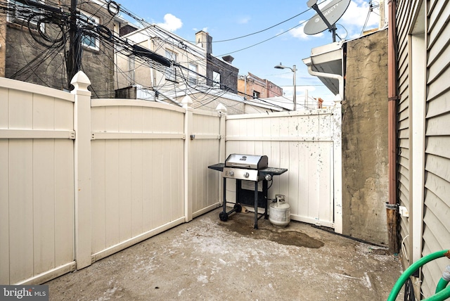 view of patio / terrace featuring grilling area, fence, and a gate