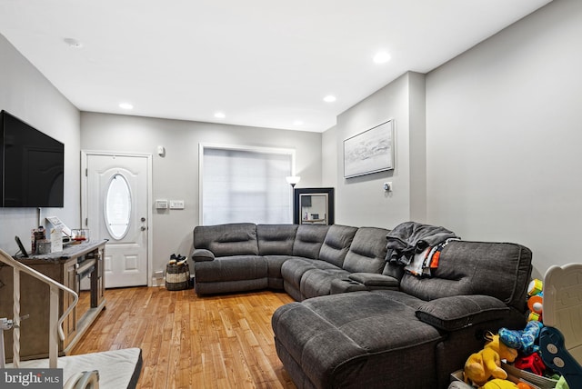 living area with light wood-type flooring and recessed lighting