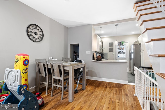 dining area featuring recessed lighting, baseboards, and wood finished floors