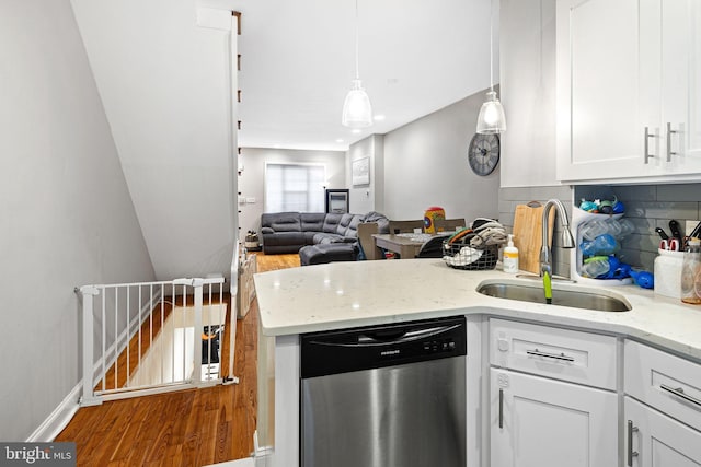 kitchen with white cabinetry, dishwasher, a sink, and light stone countertops