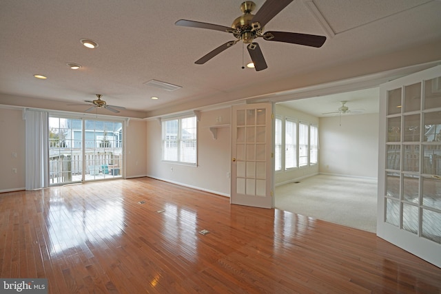 spare room featuring baseboards and wood finished floors