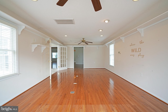 empty room with light wood-type flooring, recessed lighting, visible vents, and ornamental molding