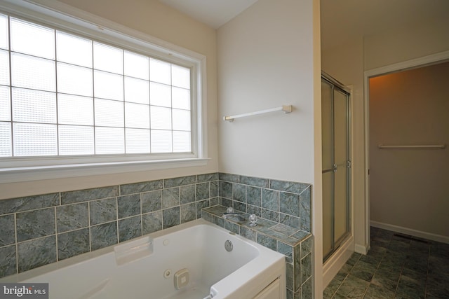 full bathroom with a whirlpool tub, a stall shower, and baseboards