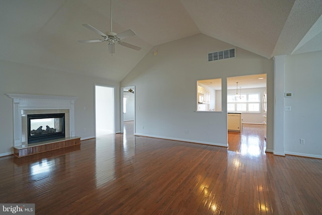 unfurnished living room featuring dark wood-style floors, ceiling fan, a multi sided fireplace, and visible vents