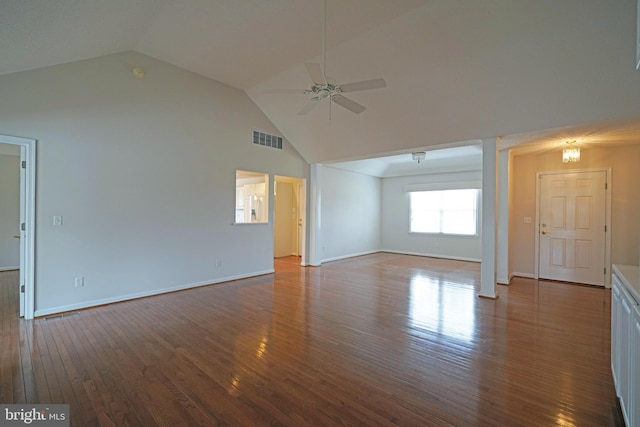 unfurnished living room with visible vents, hardwood / wood-style floors, a ceiling fan, high vaulted ceiling, and baseboards