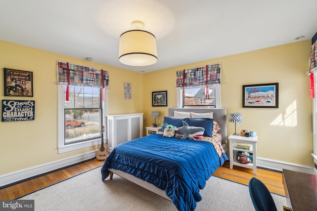 bedroom with baseboards and wood finished floors