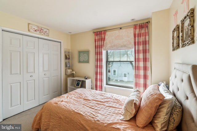 carpeted bedroom featuring a closet