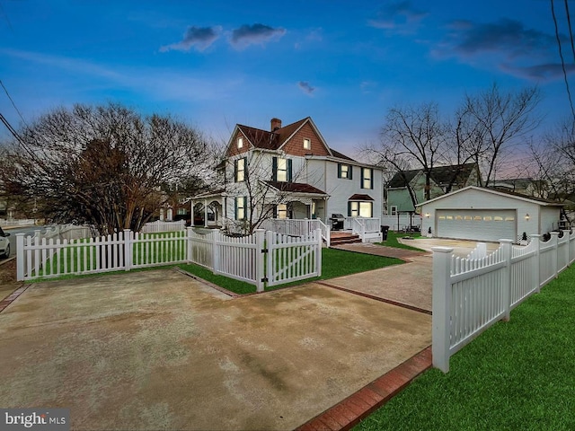 view of front of home featuring an outbuilding, a fenced front yard, a detached garage, and a chimney