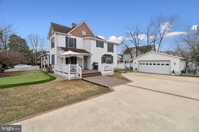 view of front of house featuring an outbuilding, a chimney, fence, a garage, and a wooden deck