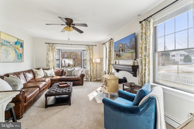 living room featuring baseboard heating, carpet flooring, and a ceiling fan