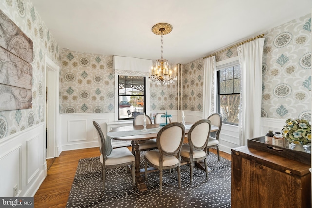 dining area with wainscoting, a wealth of natural light, and wallpapered walls