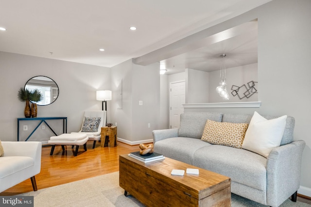 living room featuring baseboards, wood finished floors, and recessed lighting