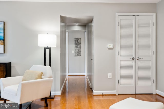 bedroom featuring a closet, wood finished floors, and baseboards