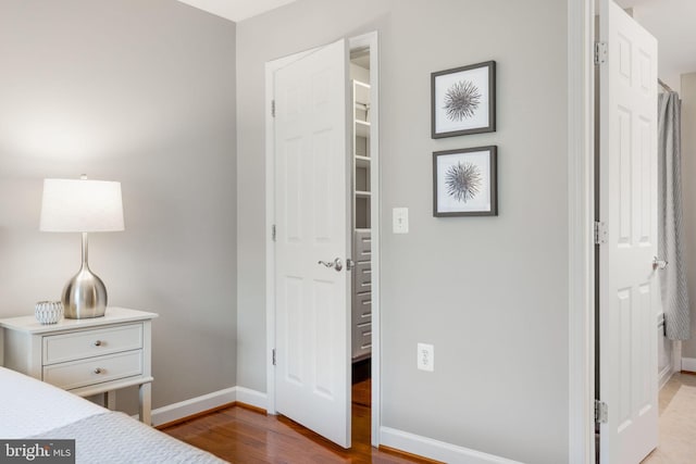 bedroom featuring wood finished floors and baseboards