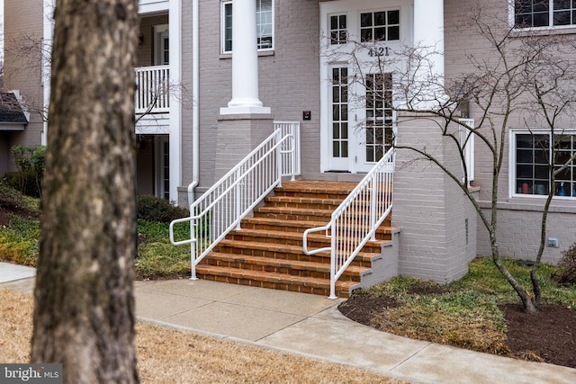 doorway to property with brick siding