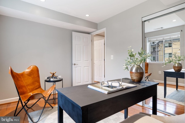 office featuring light wood-style flooring, visible vents, baseboards, and recessed lighting