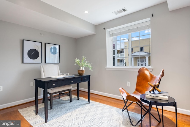 home office featuring recessed lighting, wood finished floors, visible vents, and baseboards