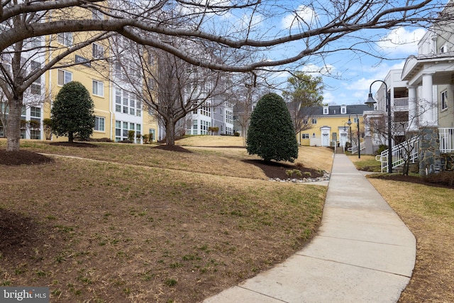 view of community with a residential view and a yard