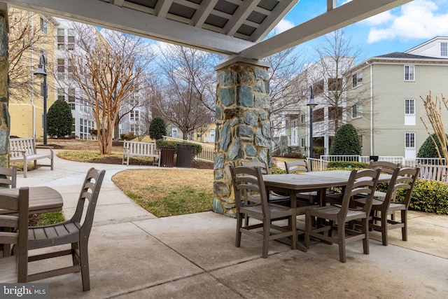 view of patio with outdoor dining area and fence