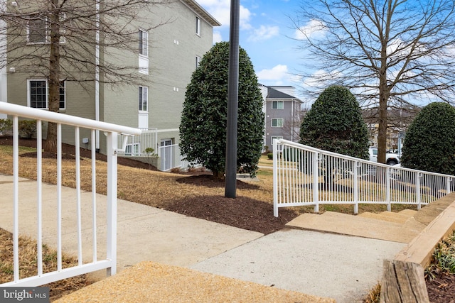 exterior space featuring brick siding and fence