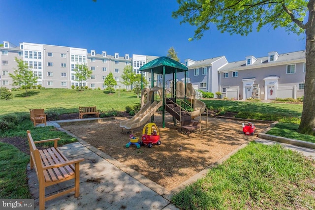 communal playground featuring a yard