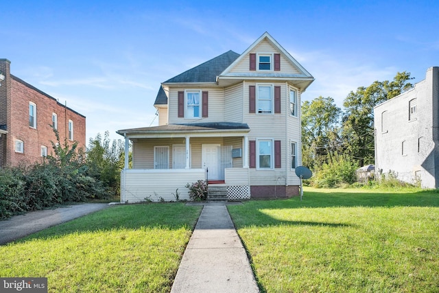 view of front of home featuring covered porch and a front lawn