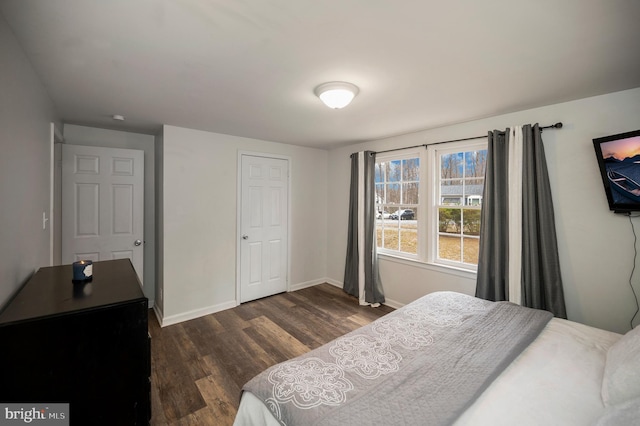 bedroom featuring dark wood-style floors and baseboards