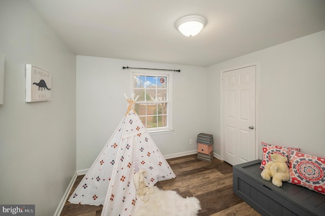 bedroom featuring dark wood-style flooring and baseboards
