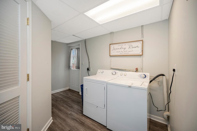 washroom featuring dark wood-style floors, washer and dryer, laundry area, and baseboards