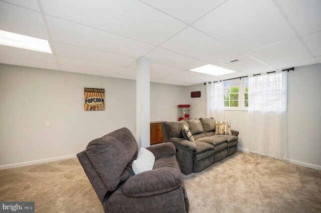 living room with light carpet, baseboards, visible vents, and a drop ceiling